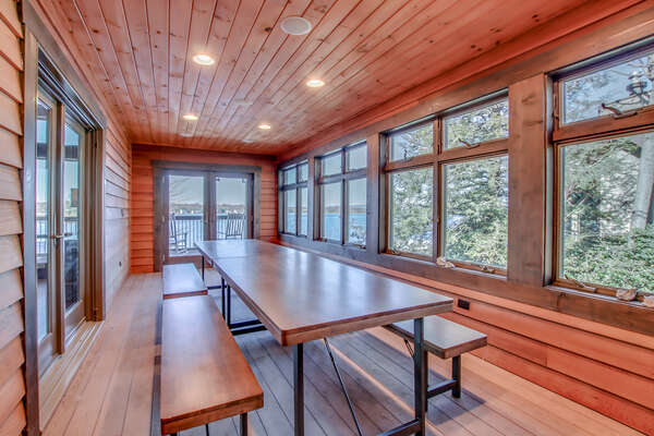 Dining room of this Poconos rental by the lake, with a large picnic style dining table.