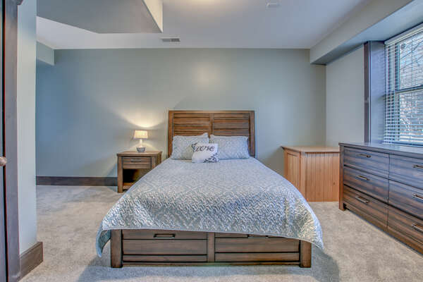 Large bed and nightstand of one of this rentals bedrooms.