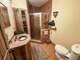 The ground floor Bathroom has a toilet, standard vanity, linen closet and corner shower