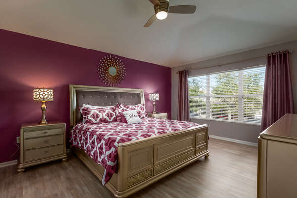 Luxurious master suite with a king bed on the second floor
