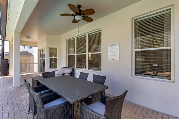 Dine al fresco underneath the covered lanai with seating for 6 at the table