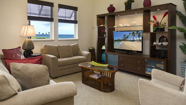 Living Area with ample seating, flat-screen TV, and coffee table.