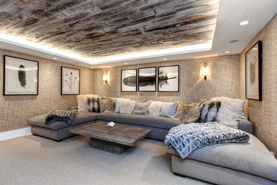 Media Room with large, cozy sectional sofa, reclaimed wood ceilings, HDTV (level 2) | Abode at Winter Lily