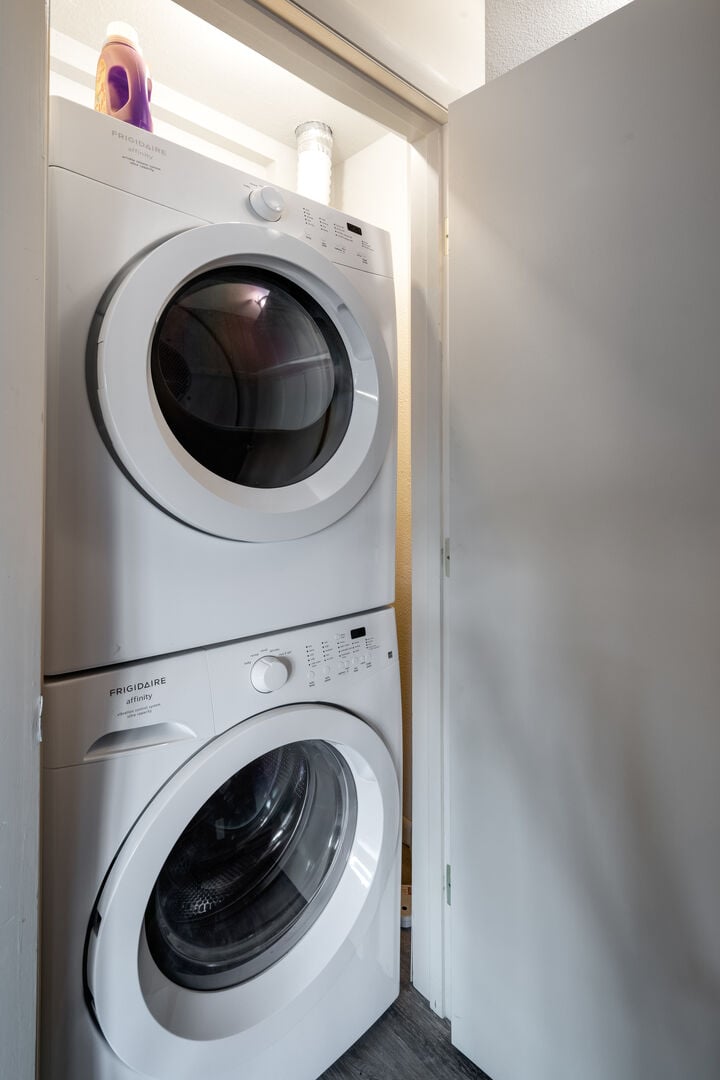 Stackable washer and dryer in the unit.