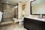 Spacious hall bathroom with large shower and double sink vanity.