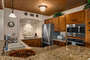 Well equipped kitchen with wood cabinets and stainless steel appliances
