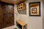 Entry with storage cubbies, bench and a hidden laundry closet..