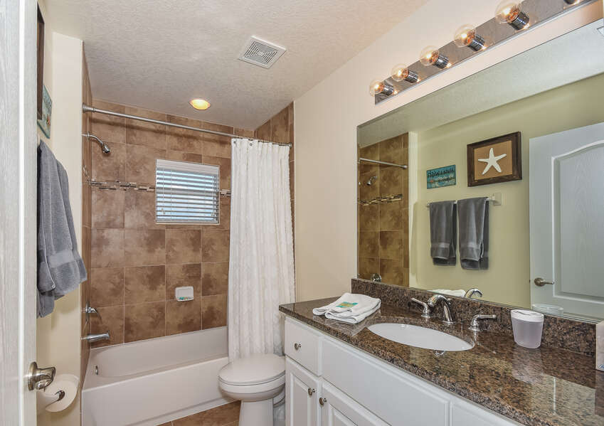 View of the bathroom with a bathtub and a toilet