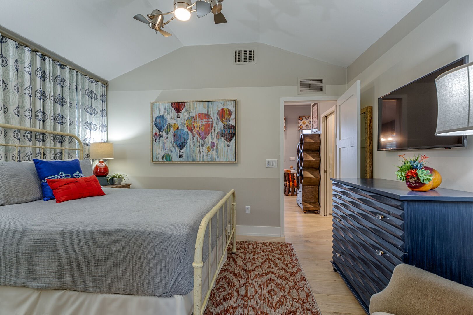 Bed, Dresser, and TV in a Bedroom at Cloud Nine