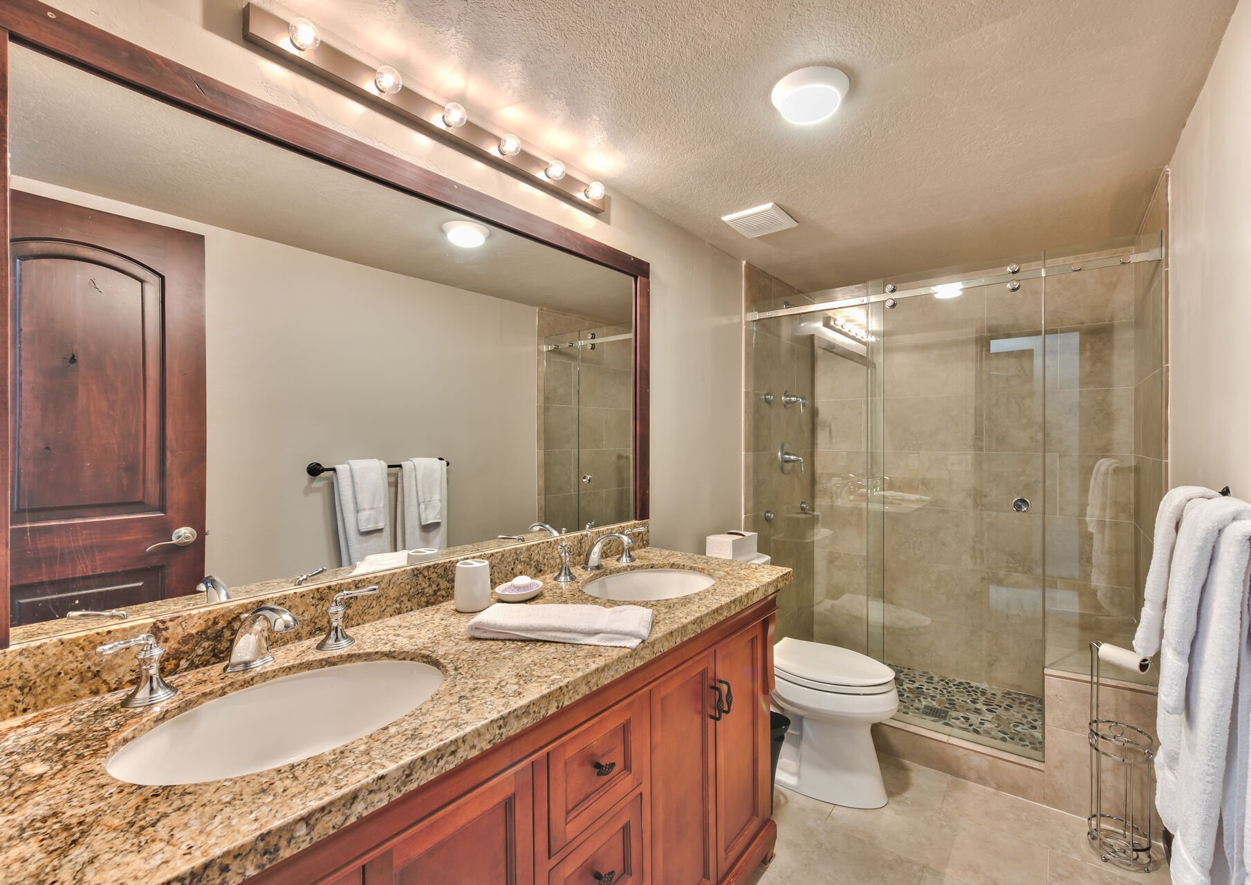 Master Bath with Dual Granite Counter Sinks and Lovely Tile Shower