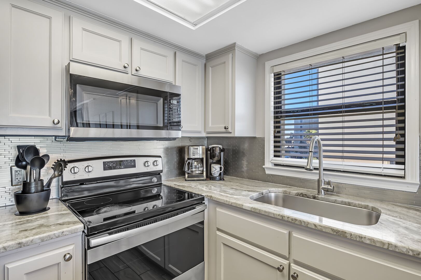 The fully equipped kitchen with stainless appliances and granite counter tops.