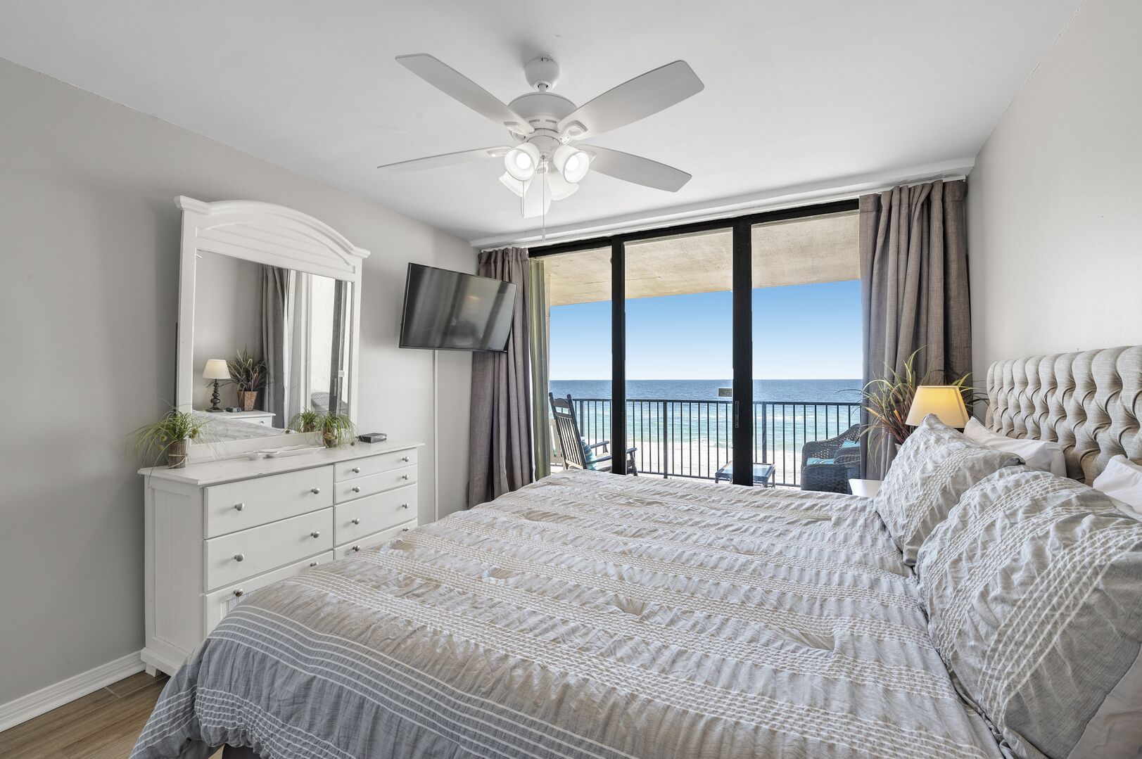 The master bedroom has a king size bed with private balcony access.