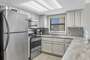 The fully equipped kitchen with stainless appliances and granite counter tops.