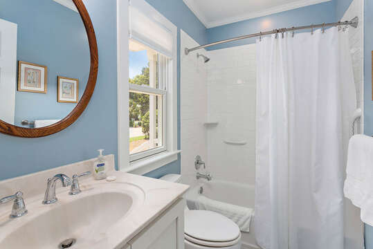 Bedroom with shower/tub combo and blue walls