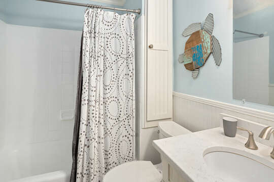 A bathroom with a tub/shower combo in Blue Skies Cottage