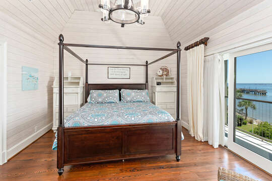 Bedroom includes four-poster bed and ocean view