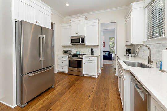 The kitchen featuring a stainless steel refrigerator, gas range and dishwasher
