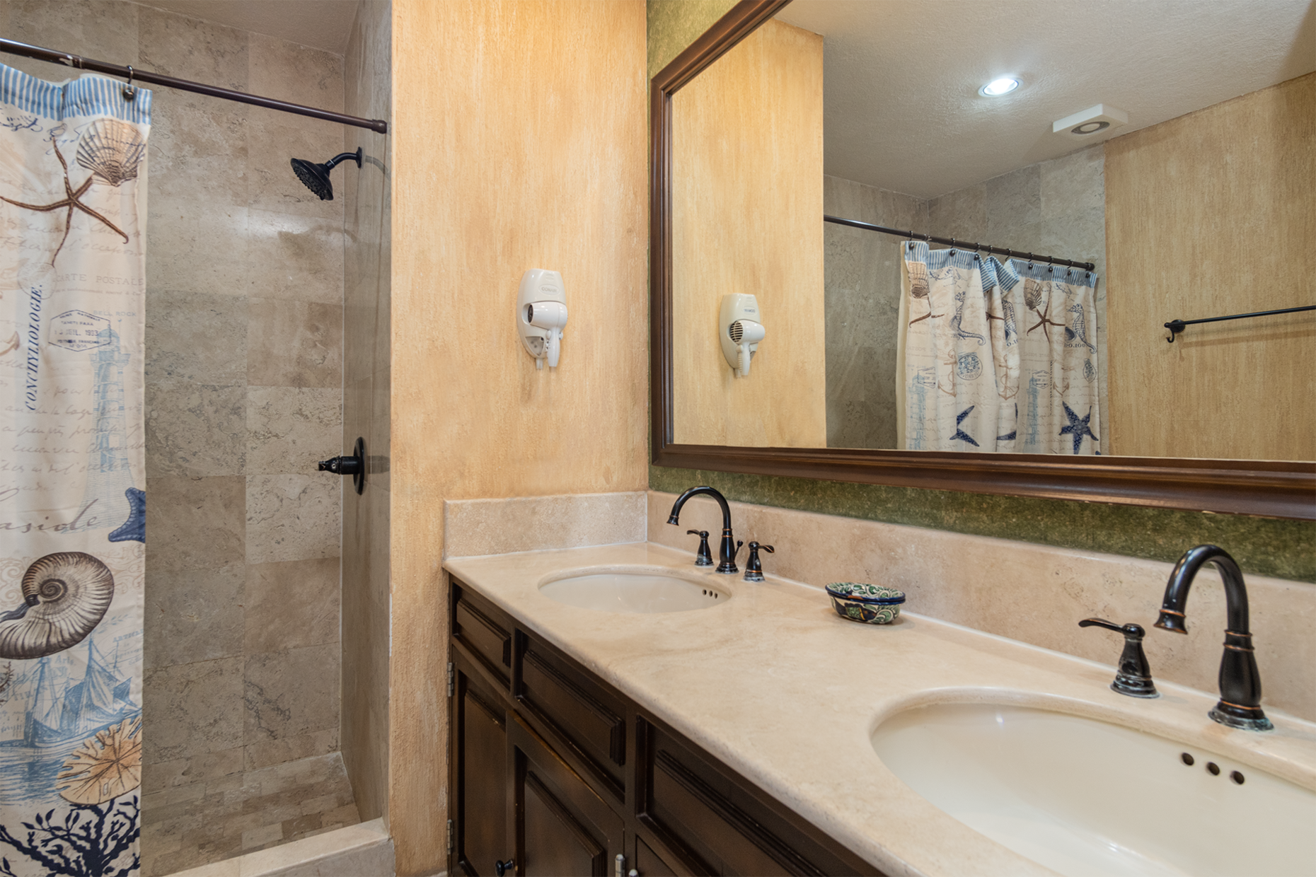 The main bathroom is private, with a shower stall and vanity.
