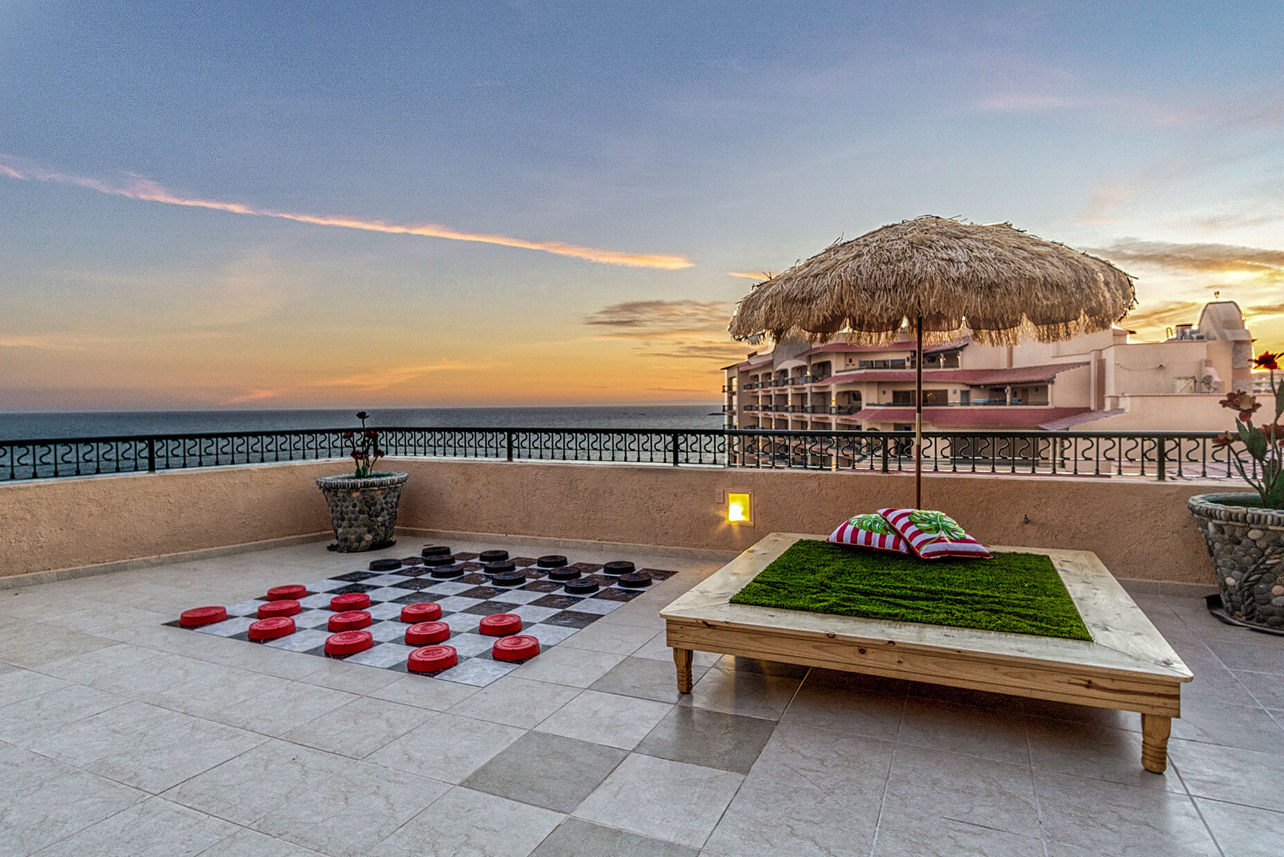 Lounger has palapa style shade and comfortable turf.