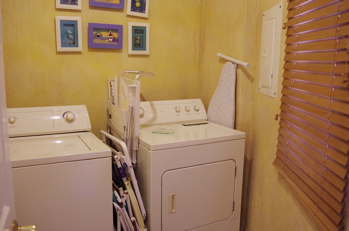 Full sized washer and dryer in separate utility room by the entrance door
