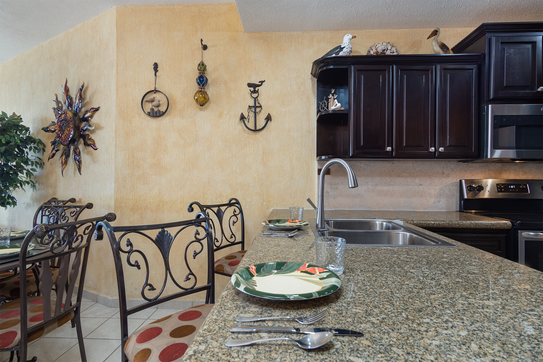 High backed seats at the kitchen counter provide an extra place to enjoy a meal.