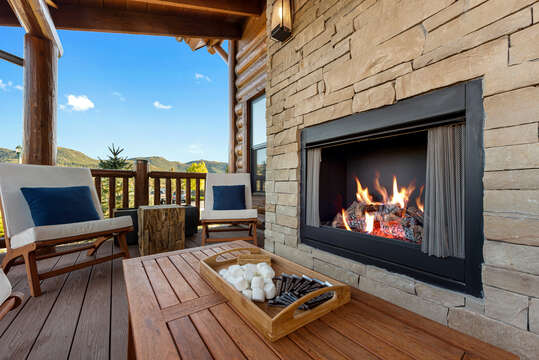 Outdoor patio with fireplace and hot tub