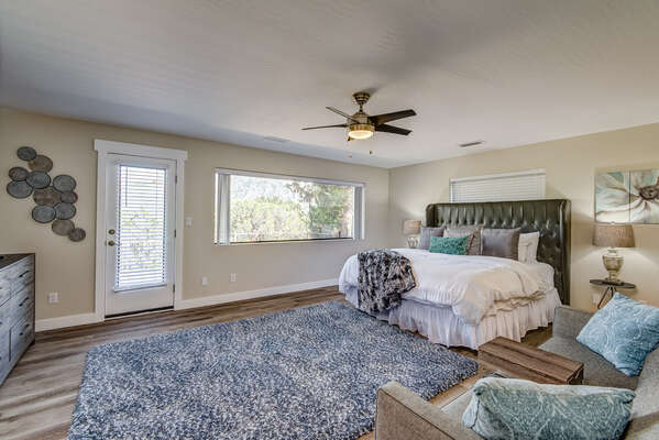 Upper Level Grand Master Bedroom with King Bed, a Big Picture Window and Deck Access