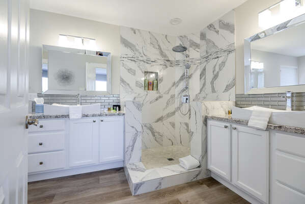 Stunning Master Bath with Dual Granite Countertop Vanities, a Marble Shower and a Soaking Tub