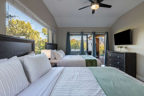 Upstairs bedroom 3 with two queen beds and sliding door to front deck and private hot tub