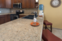 The kitchen counter has stools that offer a casual dining area