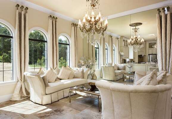 This gorgeous sitting area has natural sunlight and a wall of mirrors to create an open feeling