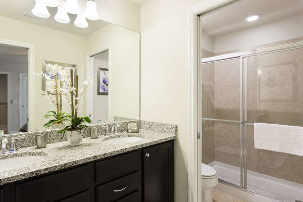 En-suite bathroom with dual vanity and walk-in shower