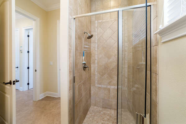 The bathroom features a walk-in shower