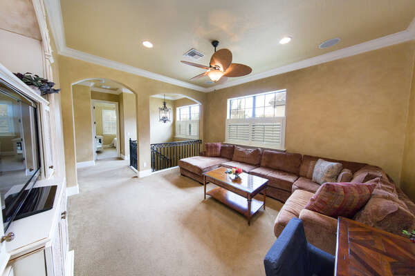 Comfortable entertainment area with plush furniture