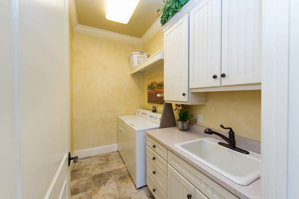 Laundry room fully equipped with washer and dryer