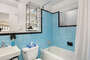 1950s Mid-Century Sky Blue Shower Tile Bathroom - Furnished Apartments in Atlanta - Cool Classic Studios On 25th
