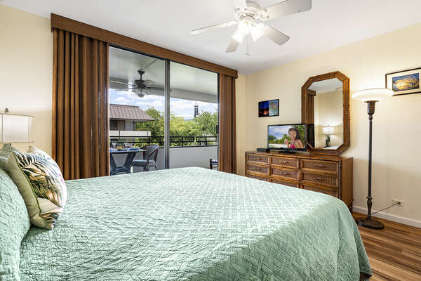 Large Bed, Drawer Dresser, Mirror, Ceiling Fan, and Sliding Doors to Lanai