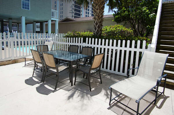Admirals Quarters A vacation home in Cherry Grove, North Myrtle Beach | pool deck table | Thomas Beach Vacations