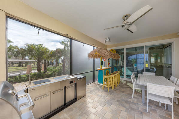 Everyone will love hanging out underneath the covered lanai with a summer kitchen and tiki bar