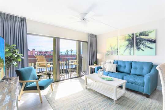 Relax in this coastal casual beach condo - living room walks out onto patio and has a 65