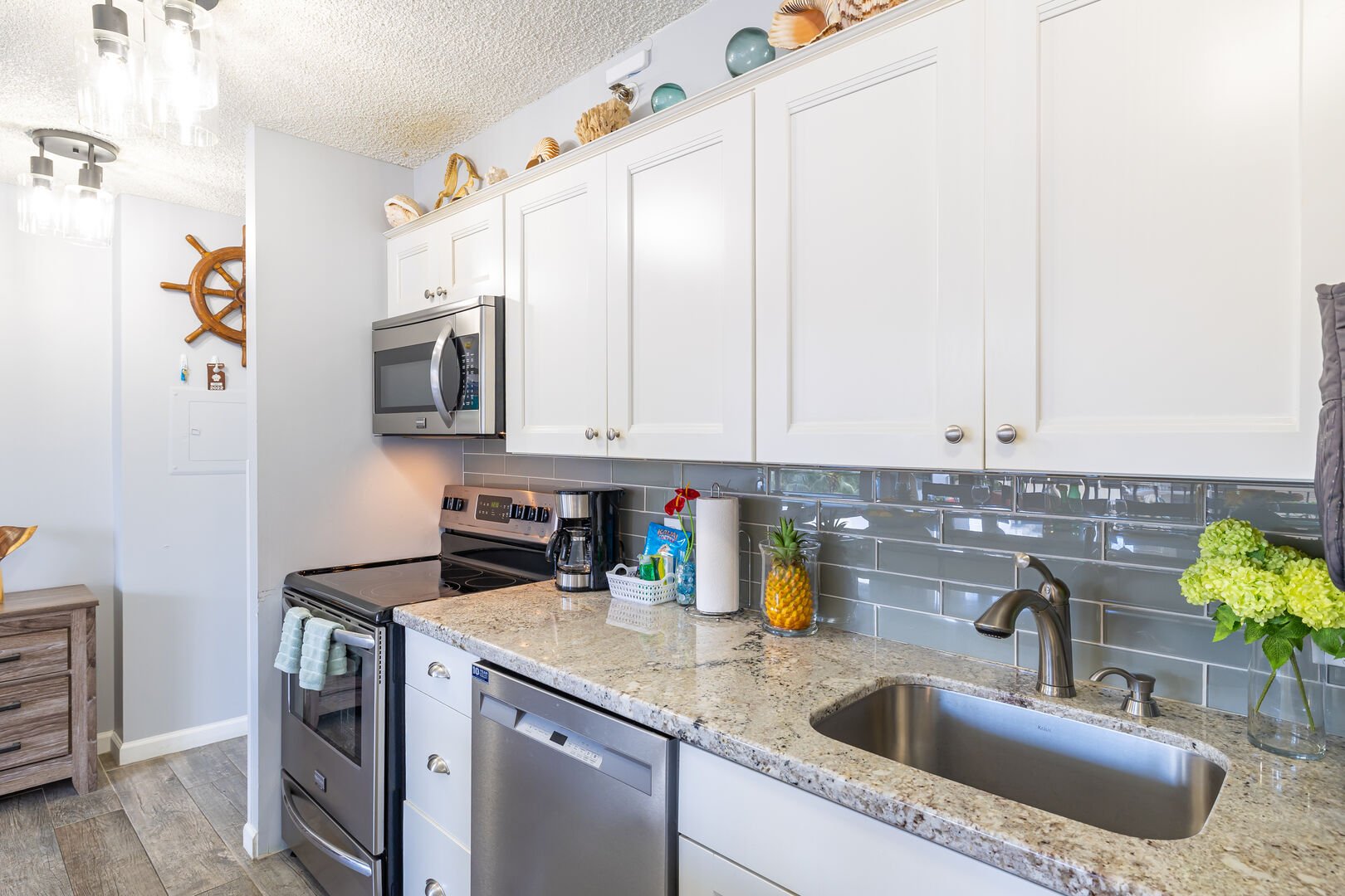 Renovated kitchen with all new appliances, including stove/oven, refrigerator, and dishwasher