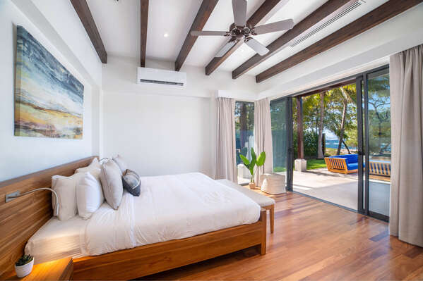 Relax in the main bedroom downstairs with a comfy king bed and a stunning beachfront view.