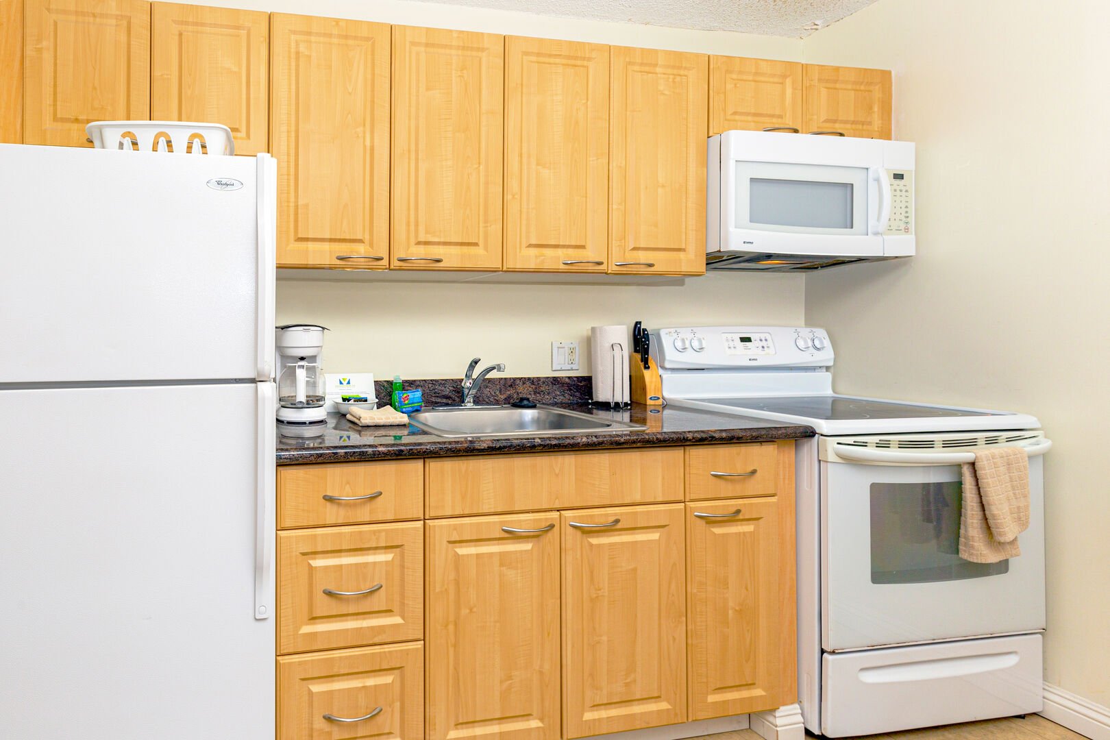 Full kitchen includes refrigerator, stove, oven, and microwave