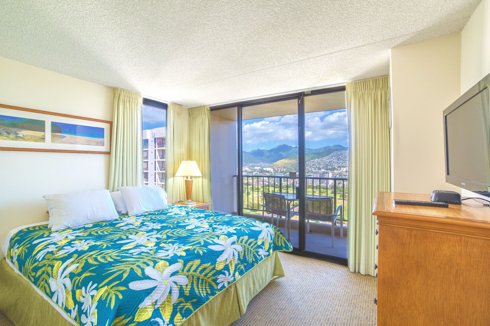 Bedroom with beautiful mountain and city views, king-size bed, and TV!