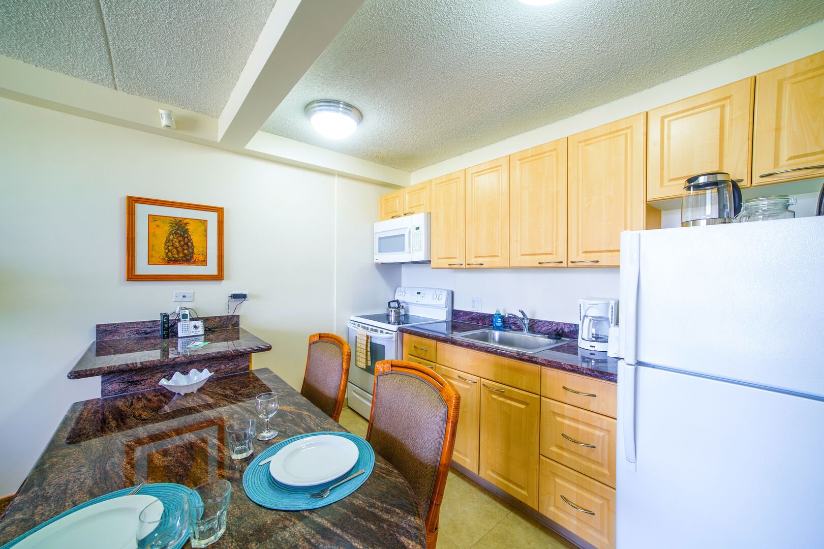 Fully equipped kitchen, complete with oven, stove, microwave, and refrigerator