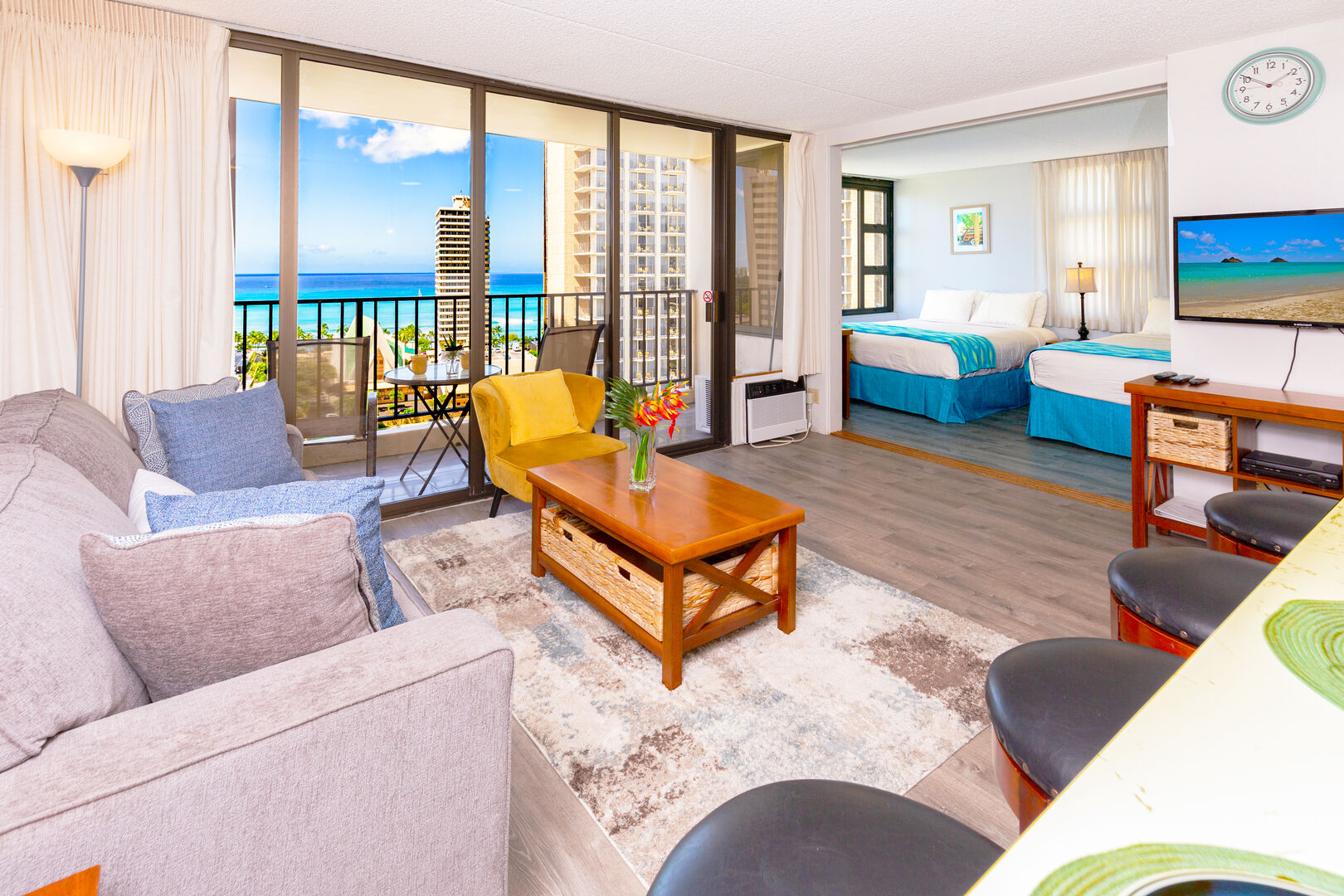 Stunning ocean view from the comfort of your own balcony and living room with a comfortable sofa bed, and coffee table.