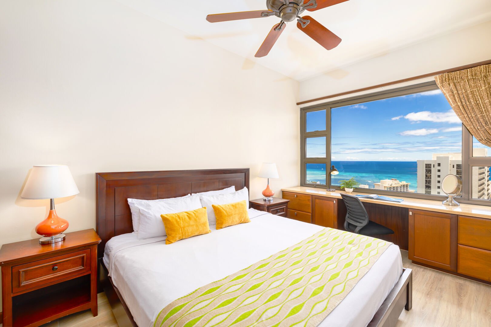 Bedroom with king-size bed, ceiling fan, designated work space with inspiring ocean views!