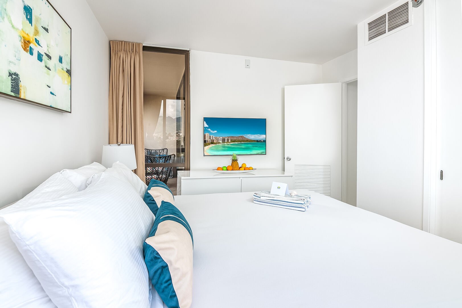 The master bedroom with a king-size bed and a 43'' smart TV.