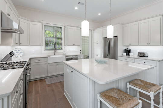 Bright, white kitchen stainless steel appliances make for an inviting space to gather
