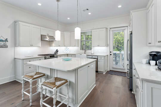 Bright, white kitchen with plenty of room to cook, prepare and gather